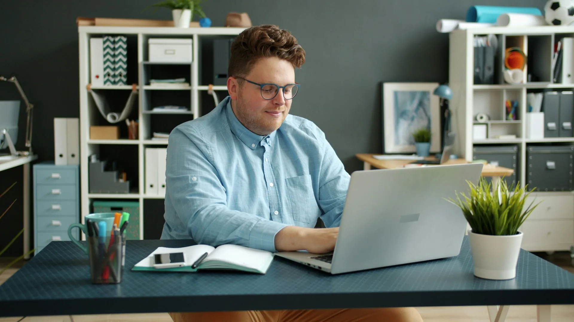 A man working on a laptop at his desk